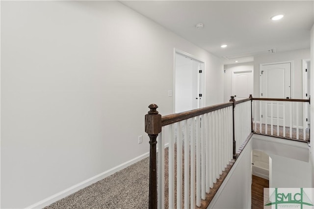 corridor with recessed lighting, an upstairs landing, and baseboards