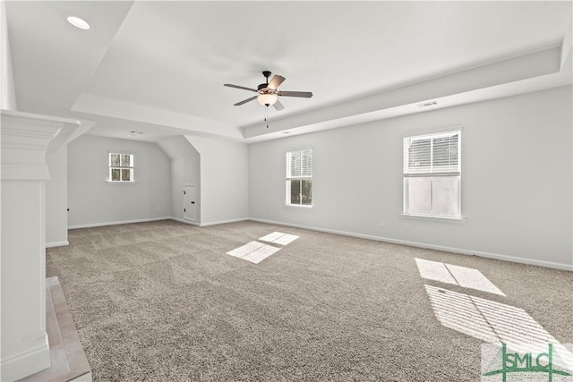 unfurnished room featuring a ceiling fan, visible vents, light colored carpet, and baseboards