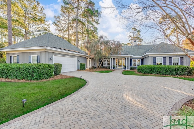 ranch-style home featuring a front yard and a garage