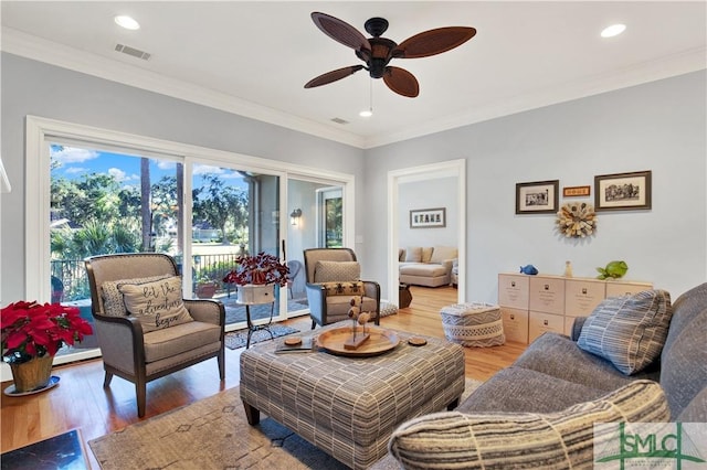 living room featuring ornamental molding, ceiling fan, and hardwood / wood-style floors