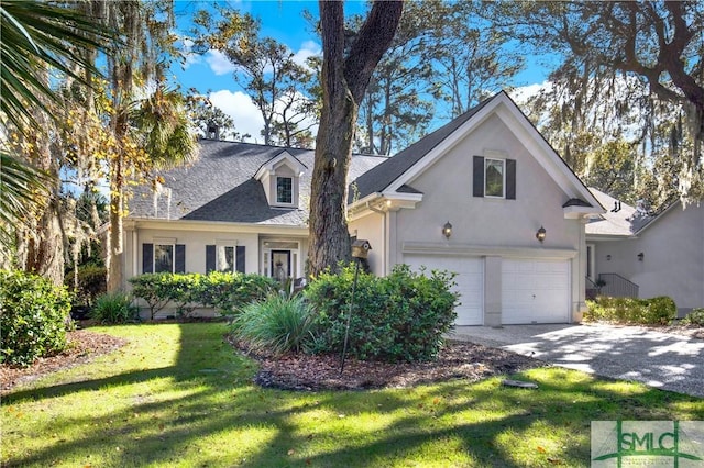 view of front of property with a front yard and a garage