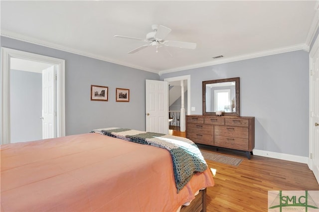 bedroom featuring ornamental molding, ceiling fan, and light hardwood / wood-style flooring