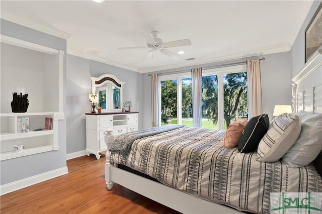 bedroom featuring hardwood / wood-style floors, ceiling fan, and ornamental molding