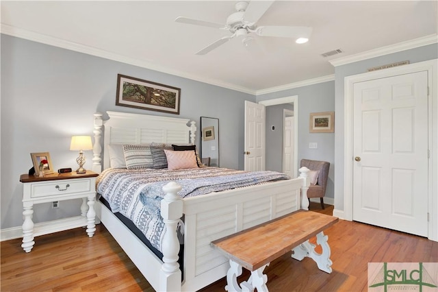 bedroom featuring wood-type flooring, ceiling fan, and crown molding