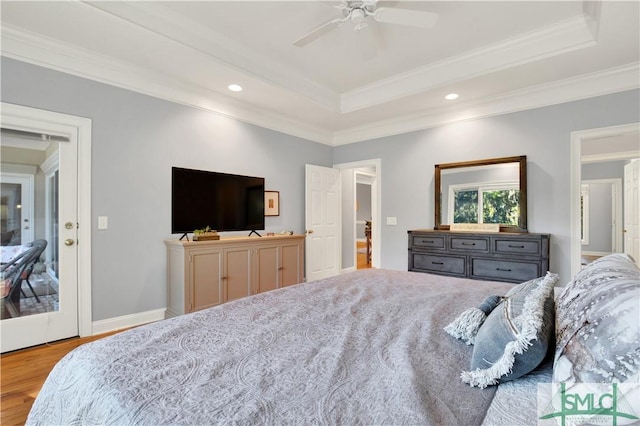 bedroom featuring ornamental molding, a raised ceiling, and ceiling fan