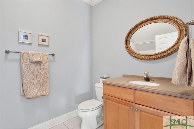 bathroom with toilet, tile patterned floors, and vanity