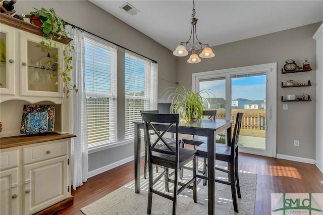 dining space with a notable chandelier and wood-type flooring