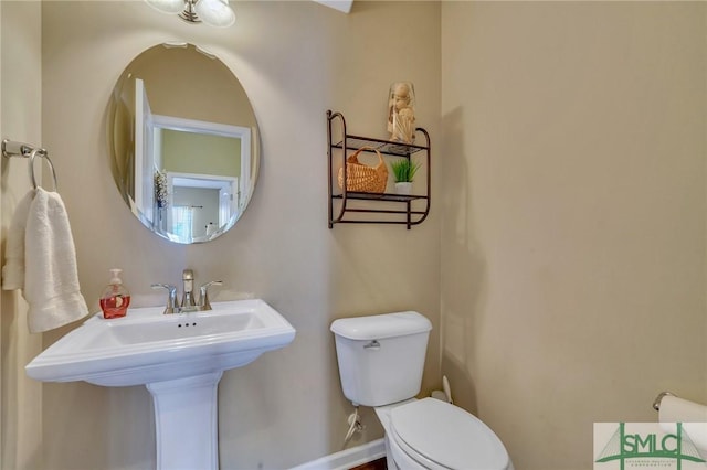 bathroom with toilet and sink