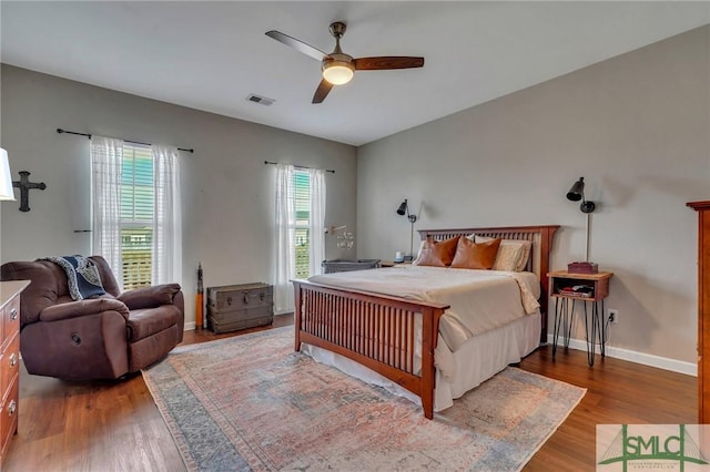 bedroom with ceiling fan and wood-type flooring