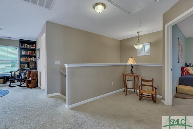 sitting room featuring light carpet