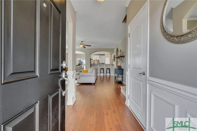 entrance foyer featuring ceiling fan, decorative columns, and hardwood / wood-style flooring