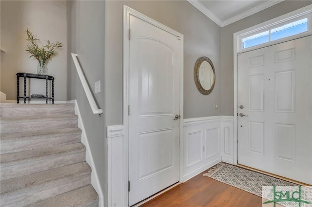 foyer featuring ornamental molding and wood-type flooring