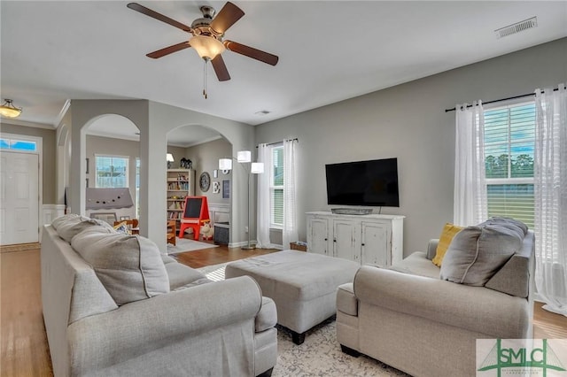 living room featuring ceiling fan, light hardwood / wood-style flooring, and a wealth of natural light