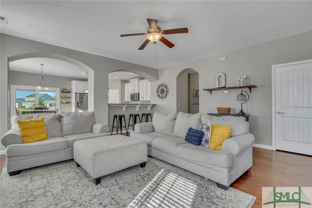 living room featuring ceiling fan and hardwood / wood-style flooring