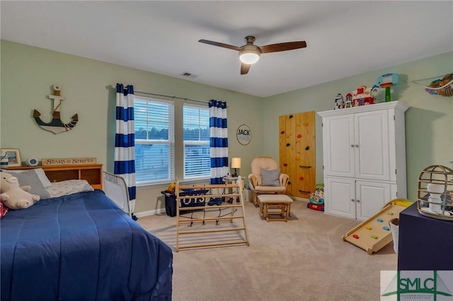 bedroom with ceiling fan and light colored carpet