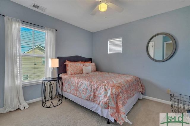 bedroom with ceiling fan and light colored carpet