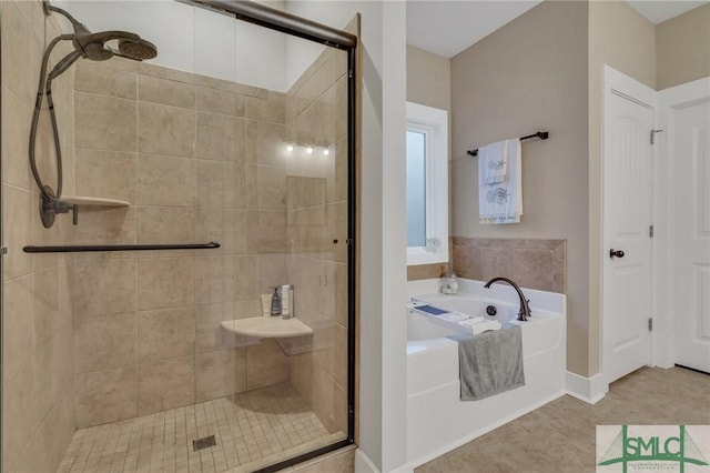 bathroom featuring tile patterned flooring, a shower stall, and a bath