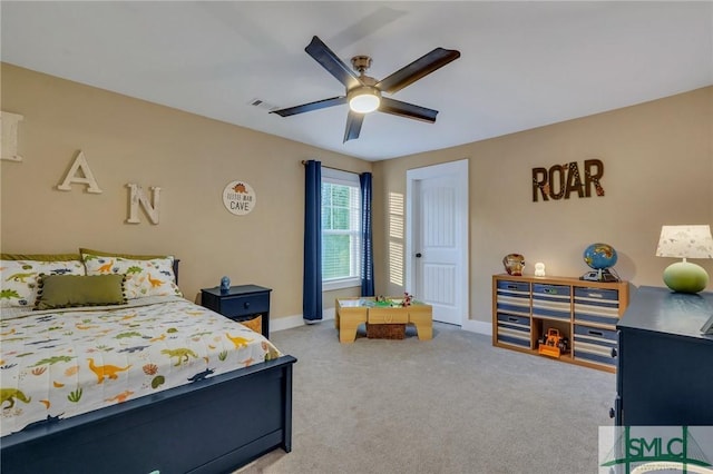 carpeted bedroom featuring visible vents, baseboards, and a ceiling fan