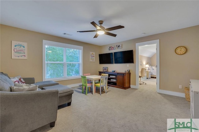 living room featuring visible vents, carpet flooring, a ceiling fan, and baseboards