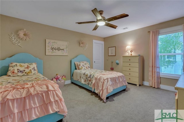 bedroom featuring visible vents, multiple windows, light colored carpet, and baseboards