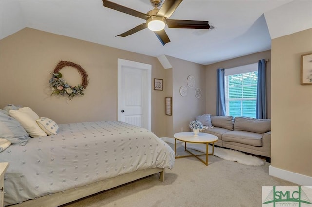 bedroom with ceiling fan, vaulted ceiling, baseboards, and light carpet