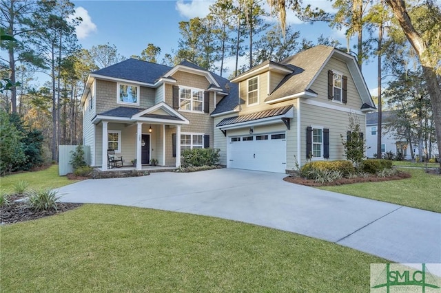 view of front of property featuring a porch, an attached garage, driveway, and a front yard