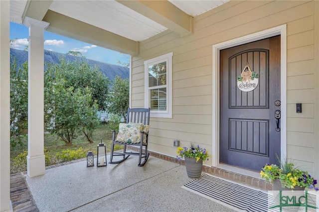 entrance to property featuring a mountain view and a porch