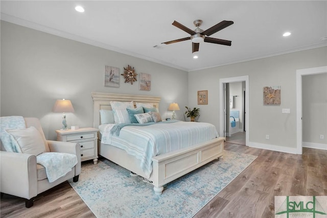 bedroom with crown molding, recessed lighting, wood finished floors, and baseboards