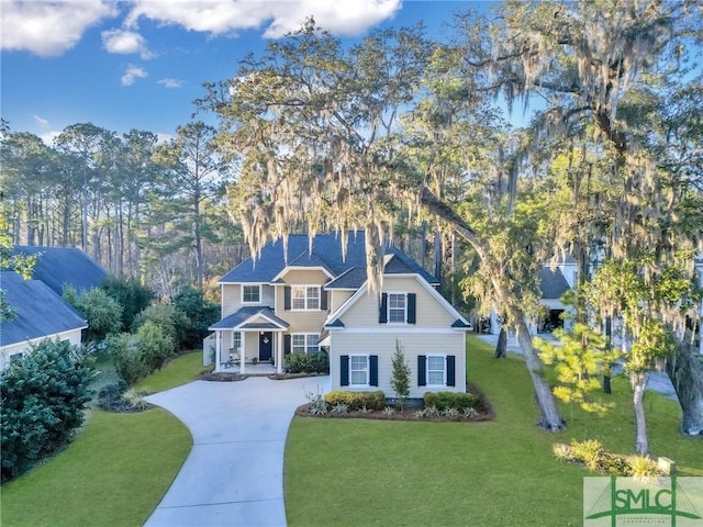 view of front of house with a front lawn and concrete driveway