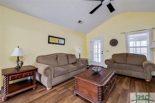 living room with ceiling fan, vaulted ceiling, and dark hardwood / wood-style floors