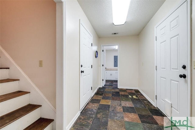 hall with a textured ceiling