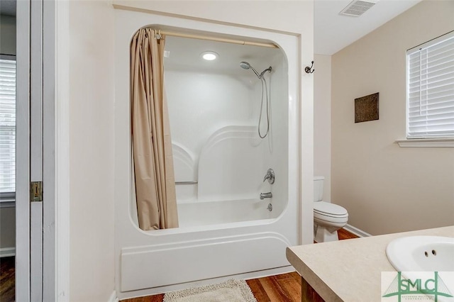 full bathroom with toilet, shower / tub combo, vanity, and hardwood / wood-style floors