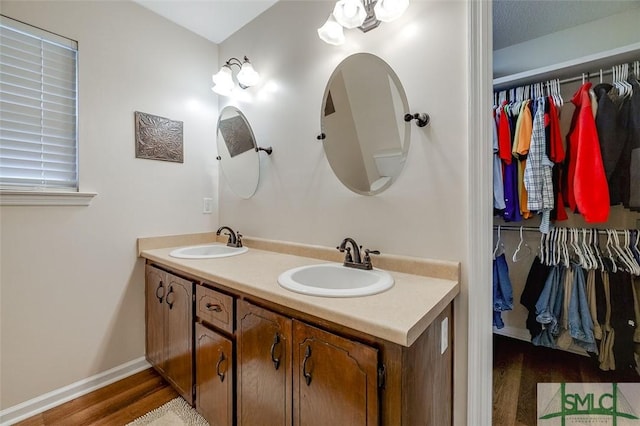 bathroom featuring a textured ceiling, hardwood / wood-style floors, and vanity