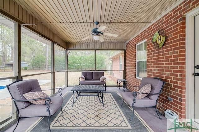 sunroom featuring ceiling fan and a wealth of natural light