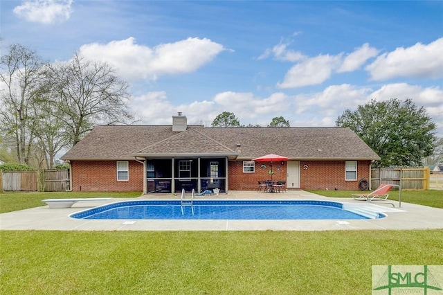 view of pool featuring a diving board, a yard, and a patio area