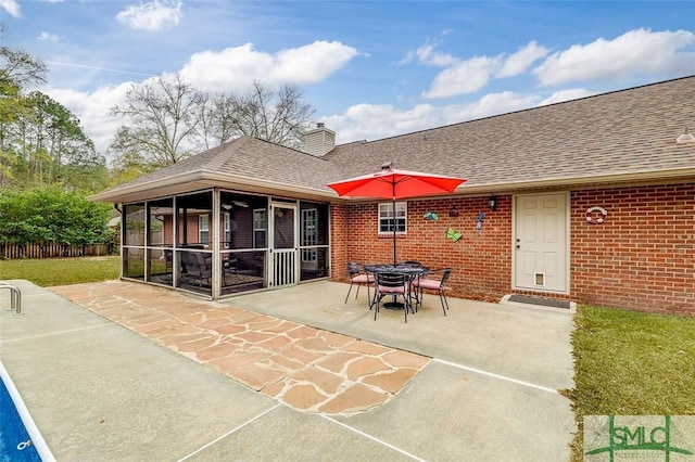 view of patio / terrace featuring a sunroom