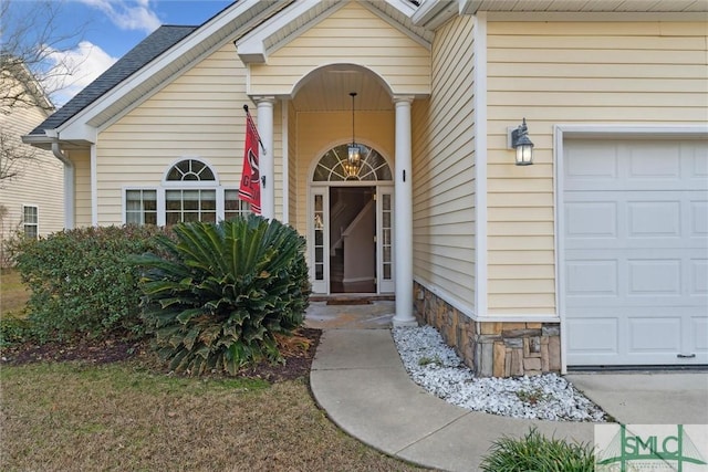 doorway to property with a garage