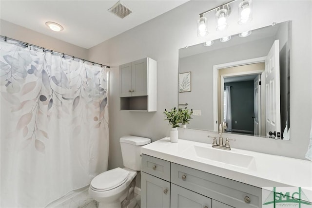 bathroom featuring toilet and vanity