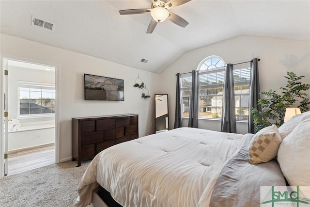 bedroom with ceiling fan, lofted ceiling, and carpet flooring