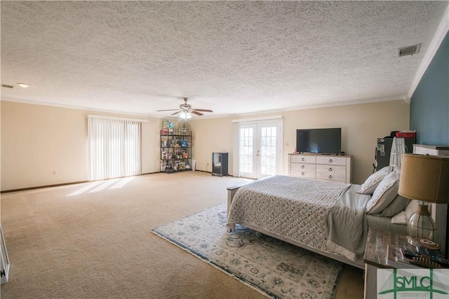 bedroom with ceiling fan, french doors, carpet floors, and a textured ceiling