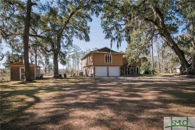 view of side of property featuring a storage shed and a garage