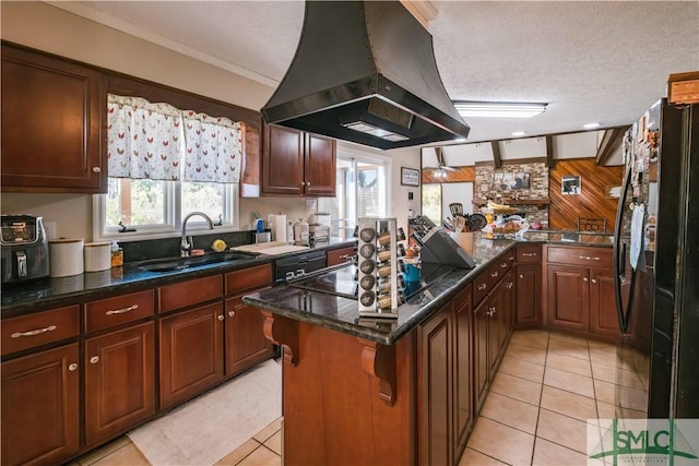 kitchen with a textured ceiling, black appliances, island exhaust hood, sink, and light tile patterned floors