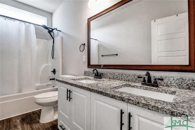 full bathroom featuring hardwood / wood-style flooring, toilet, shower / bath combination with curtain, and vanity