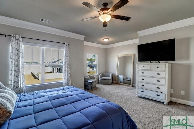 carpeted bedroom with ceiling fan and ornamental molding