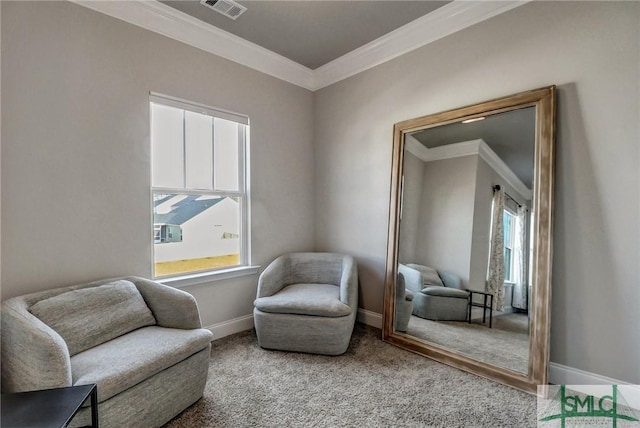 living area featuring crown molding and carpet