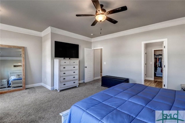 carpeted bedroom with ceiling fan and ornamental molding