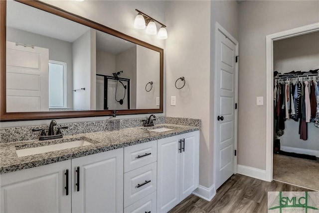 bathroom featuring vanity, hardwood / wood-style floors, and an enclosed shower