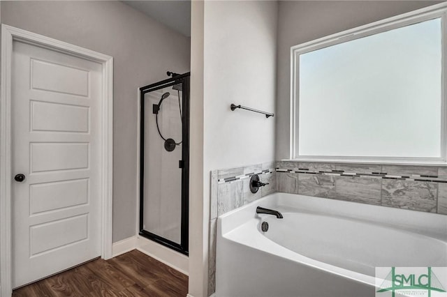 bathroom featuring separate shower and tub and hardwood / wood-style floors