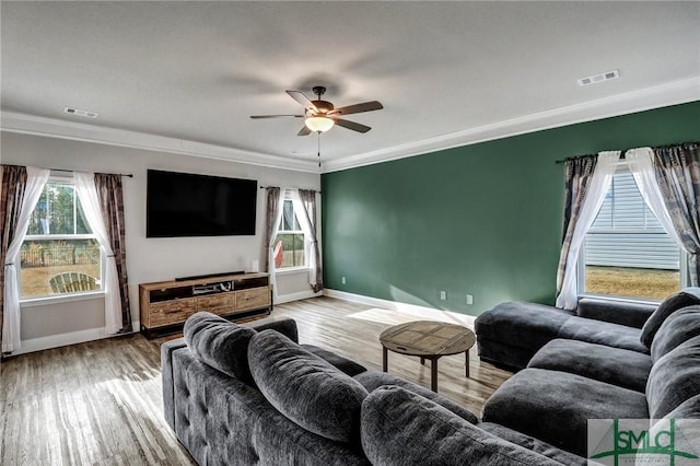 living room with light hardwood / wood-style floors, crown molding, and ceiling fan