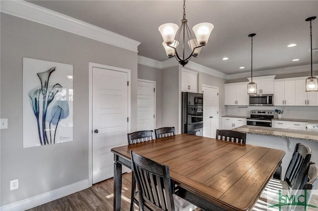 dining room featuring an inviting chandelier, crown molding, and dark hardwood / wood-style floors